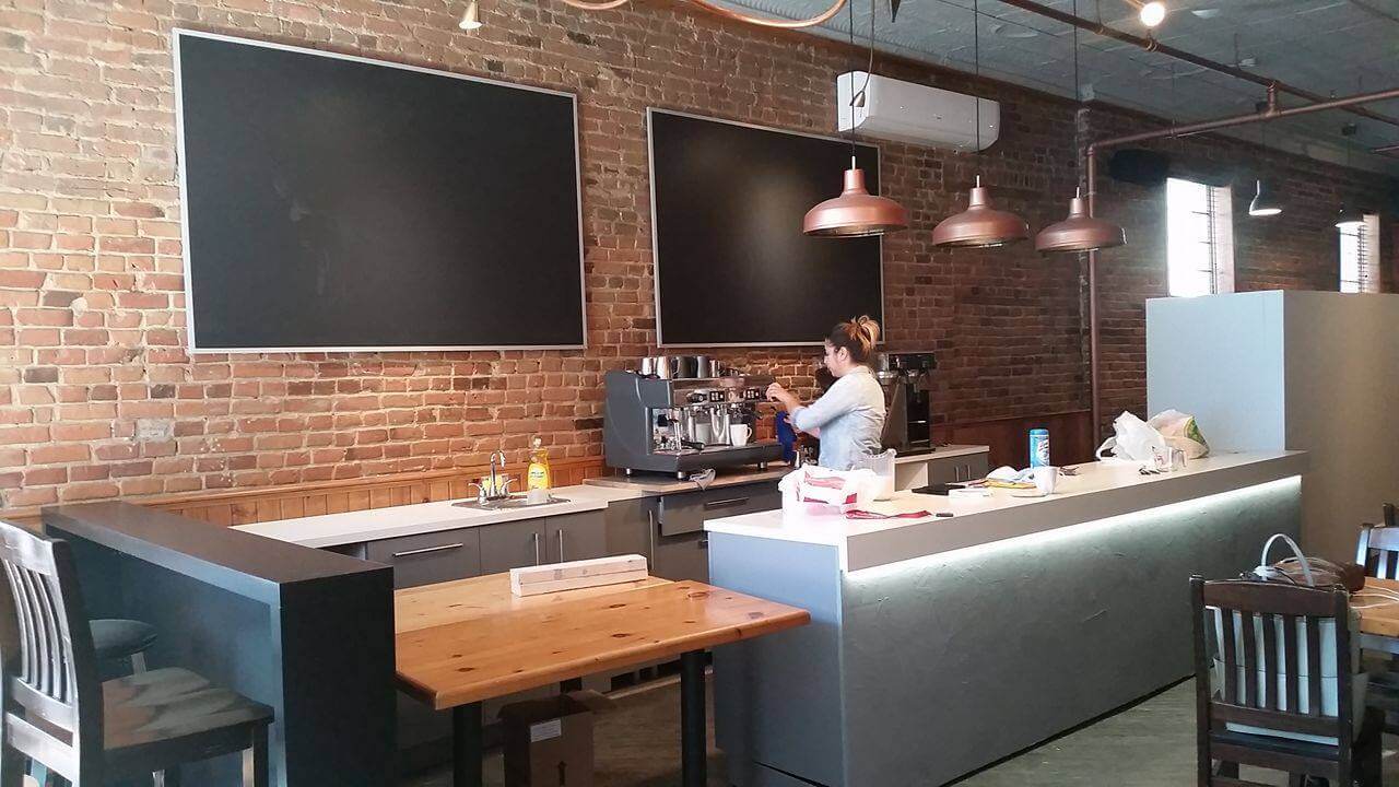 Black boards on a brick wall in a coffee shop